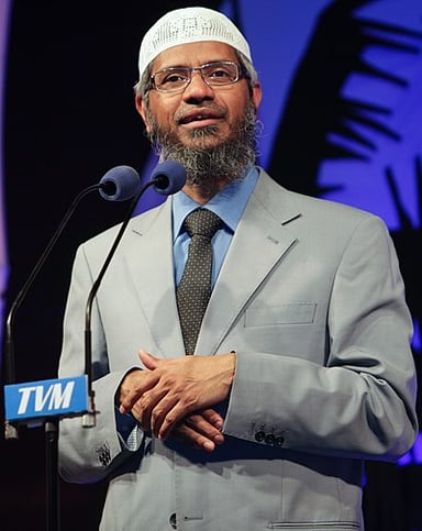 Which famous British personality did Zakir Naik debate on the topic of "Islam and the 21st Century"?