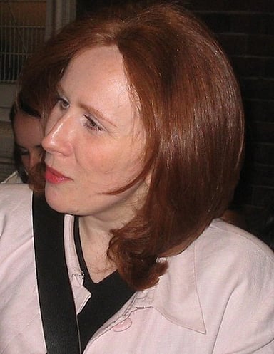 Under which name did Catherine Tate start her professional acting career?