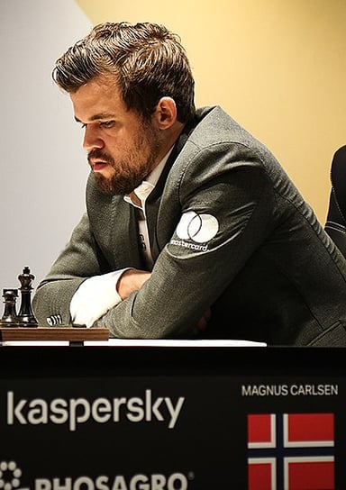 In which tournament did Carlsen first finish first in the top group?