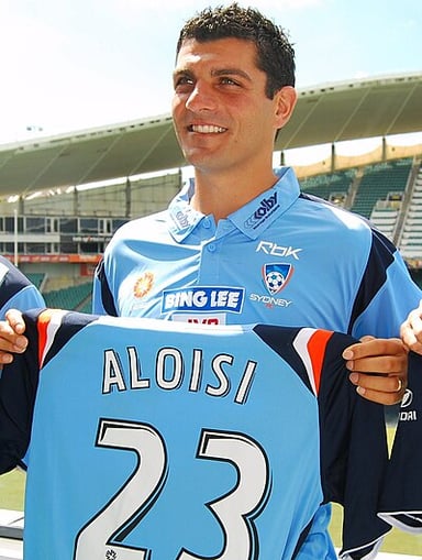 John Aloisi was the first Australian ever to play and score in which league?