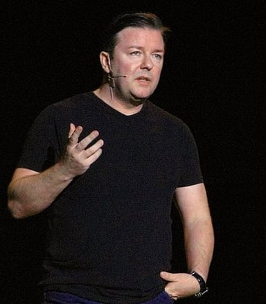 Which band did Ricky Gervais manage before turning to comedy?