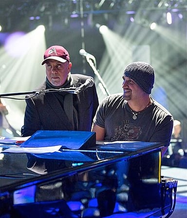How many self-penned Top 40 hits did Billy Joel produce across the 20 years of his solo career?