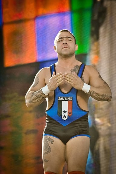 Which title did Santino Marella win in his debut match at WWE?