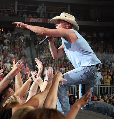 Has Kenny Chesney recorded more than 40 Top 10 singles on the U.S. Billboard Hot Country Songs and Country Airplay charts?