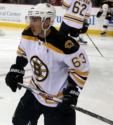 Who told Marchand to stay home and report that fall for training camp in 2009?