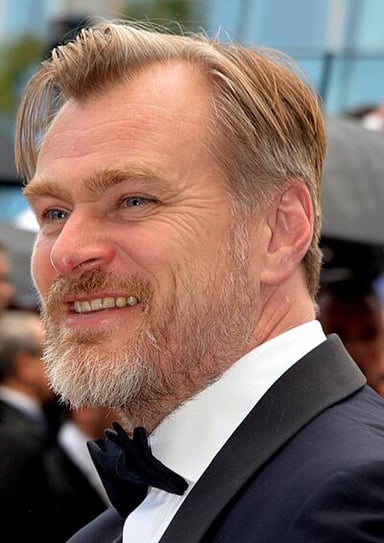 Which Christopher Nolan film earned him his first Academy Award nomination for Best Director?