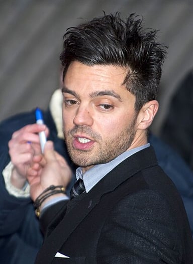 Dominic Cooper is known for his roles in what type of characters?