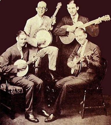 What age did Jimmie Rodgers win his first local singing contest?