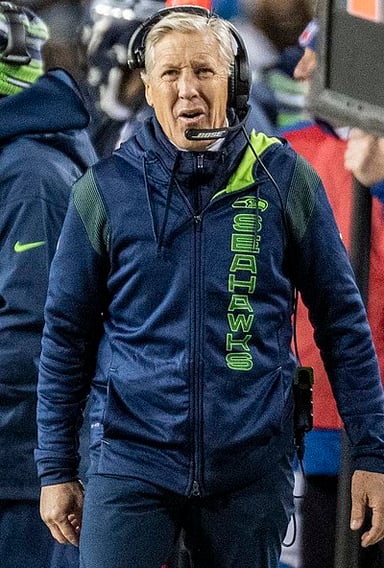 How many years did Pete Carroll coach professionally before moving to college football?