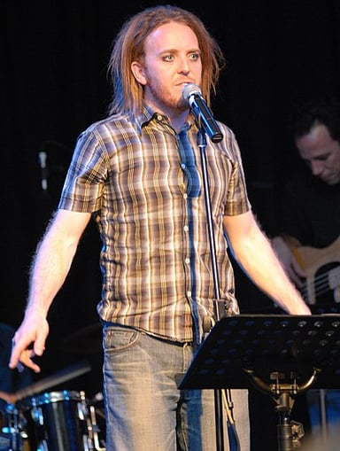 What was Tim Minchin's first performance role on TV?
