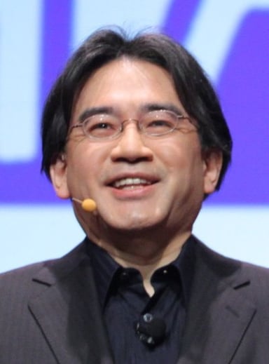 Which game series did Satoru Iwata help develop after becoming the president of HAL Laboratory?