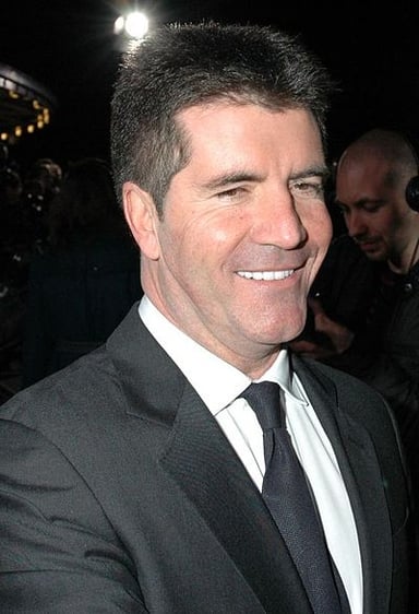 Which boy band was signed by Simon Cowell?