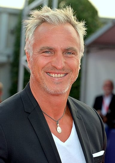 Which TV channels is Ginola a regular contributor on?