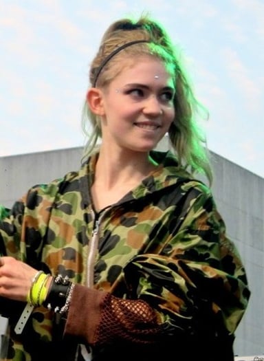 Which musical genre is Grimes NOT associated with?