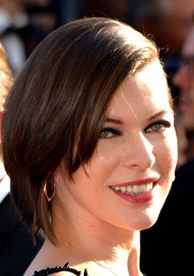 In what year was Milla Jovovich deemed the highest-paid model in the world by Forbes?
