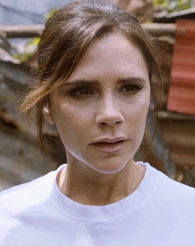 Which Spice Girls' single features Victoria Beckham's first solo verse?