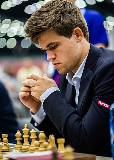 At what age did Magnus Carlsen become the youngest grandmaster?
