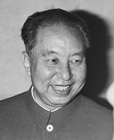 Hua Guofeng held the top offices of the government, party, and the military after the deaths of whom?