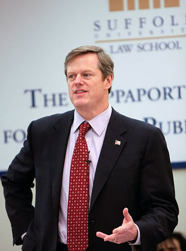 Which health benefits company did Charlie Baker serve as CEO for ten years?