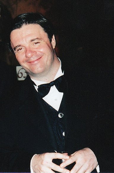 Which playwright did Nathan Lane frequently collaborate with?