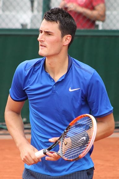 In which tournament did Bernard Tomic win his first junior Grand Slam singles title?