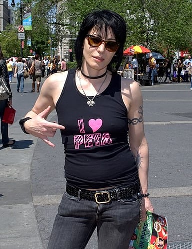 Other than singing and playing guitar, what is another role Joan Jett takes on in her music?