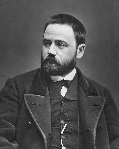 Which literary school is Émile Zola best known for?