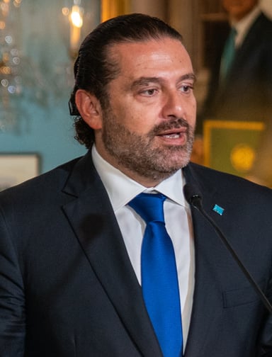 In which year did Hariri return to Lebanon after three years living overseas?