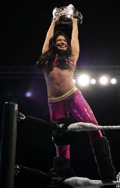 Which title did Melina win first in WWE?