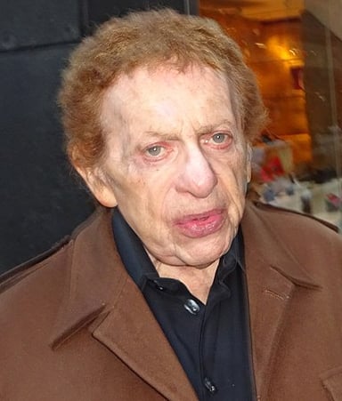 Which of the following describes Jackie Mason's voice and delivery?