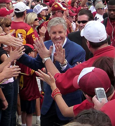 Before his current position, which university's football team did Pete Carroll head coach?