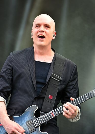 Devin Townsend's trademark production style is often compared to which artists?