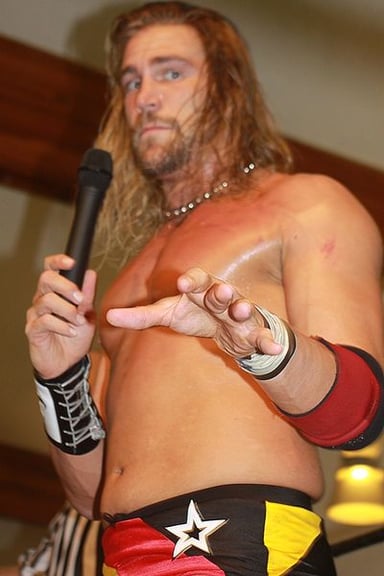 Which wrestling company is Chris Hero currently signed to?