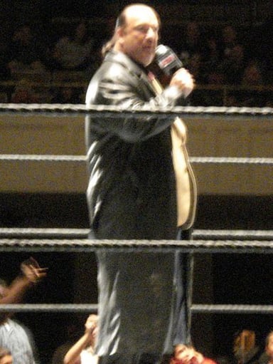 Which wrestling promotion did Paul Heyman work for as a photographer before becoming a manager?