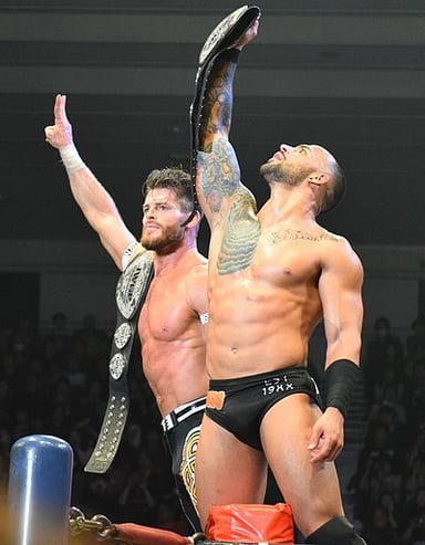 Under what moniker did Ricochet officially take when he signed with WWE in 2018?