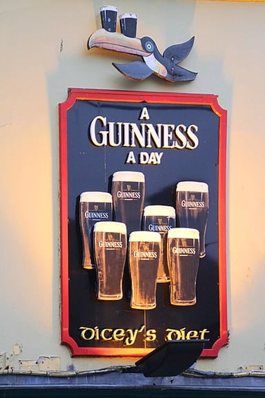 In which year did Guinness merge with Grand Metropolitan?