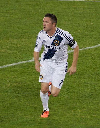 In which year did Robbie Keane announce his retirement from professional football?