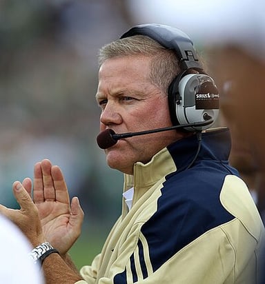 Which university did Brian Kelly begin head coaching in 2022?