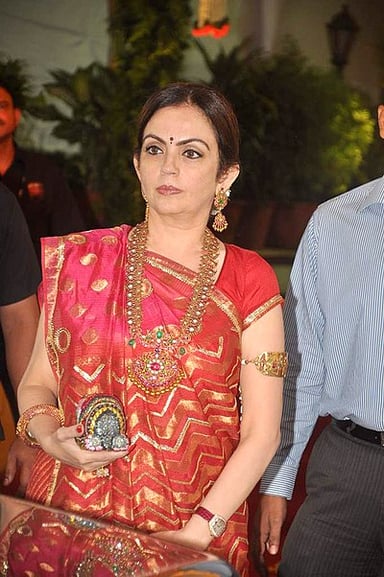 In which year did Nita Ambani become the first Indian woman to become a member of the IOC?