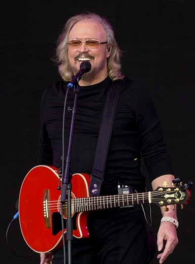How many consecutive Billboard Hot 100 number ones does Barry Gibb share with John Lennon and Paul McCartney?