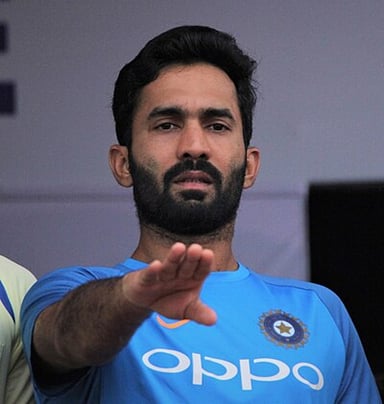 What is Dinesh Karthik's primary role in the cricket team?