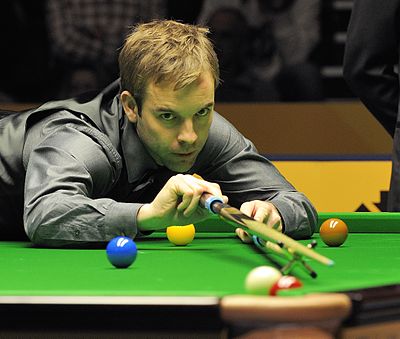 What color is usually associated with Ali Carter's waistcoats?