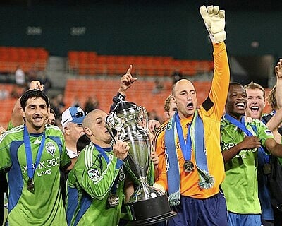 What is the name of the marching band that supports Seattle Sounders FC at each home match?