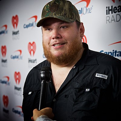 What instrument does Luke Combs typically play?