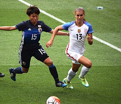 Who is the only other American woman to score 20 goals and provide 20 assists in the same calendar year apart from Alex Morgan?