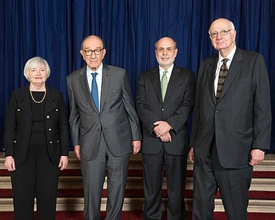 What did Bernanke chair for George W. Bush before the Fed Chairman role?
