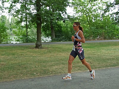 What was Chrissie's profession before turning professional in triathlon?