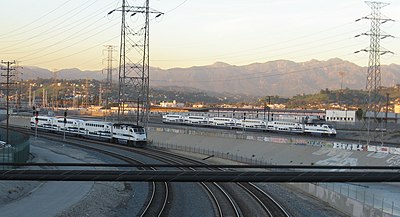 Which commuter rail system does Metrolink connect with in San Diego County?