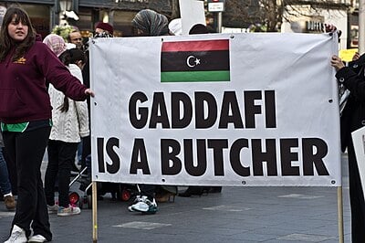What is the religion or worldview of Muammar Gaddafi?