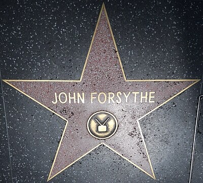 In which film did John Forsythe star with Shirley MacLaine?